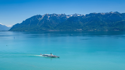 A vintage paddle wheel boat cruises from Montreux on Lake Geneva