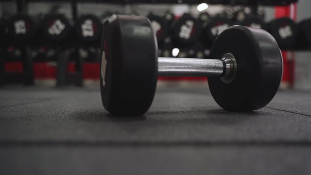 One heavy dumbbell fell on floor in gym