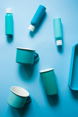 Color textured background made with three bottle of blue painting and different tonality disposed inside a blue container.