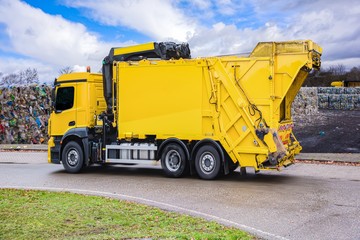 Urban recycling waste and garbage services , Bright yellow truck