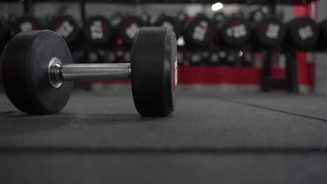 Heavy and training dumbbell fell on floor in gym