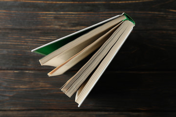 Book on wooden background, top view. Self-development
