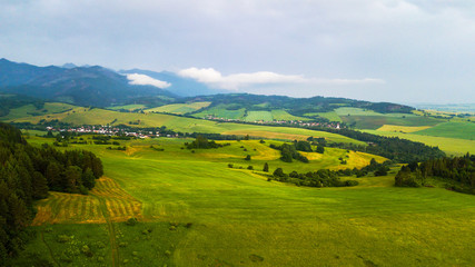 Aerial view of a green field in the Tatra Mountains in summer