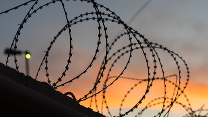 Sunset behind the barbed wire along the border. Sochi, Russia.