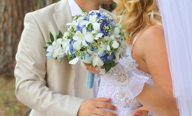 Bride holding the wedding bouquet, with succulent flowers, close-up