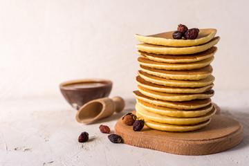 Fresh sweet pancakes with chocolate jam, cinnamon sticks and marshmallows on a gray background with place for your text.