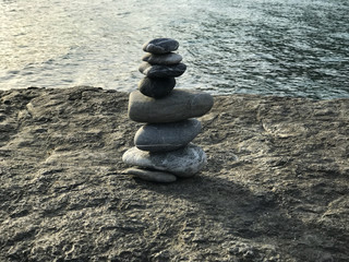 Cairn on the background of sea sunset , dawn.