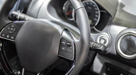 Modern car steering wheel with multifunction control switch.