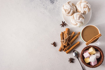 cup of hot coffee with milk and aromatic spices and sweet marshmallows and cookies for a good...