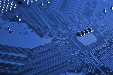 Close up of colored micro circuit board. Abstract technology background. phantom classic blue color