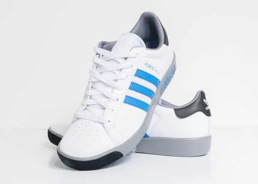london england 05 05 2018 Adidas Forest Hills White grey and blue vintage sneaker trainers. Blue stripe adidas trainers stylish retro football street fashion. famous three stripes Stock Adobe Stock