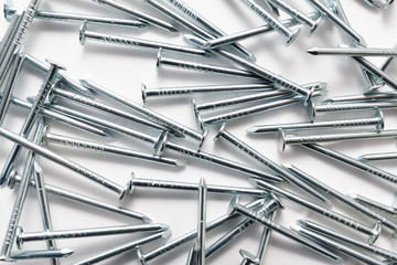 construction metal nails on white background