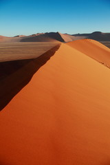 Fototapeta na wymiar Huge Red sand dunes in Sossusvlei desert in Namibia in the sunrise