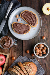 Healthy breakfast, slices of whole grain bread with apple spread made from cocoa powder, roasted ground hazelnuts and dark chocolate