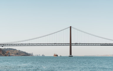 A view from the water of a huge suspension bridge 