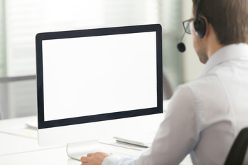 Male call center agent in headset consult client