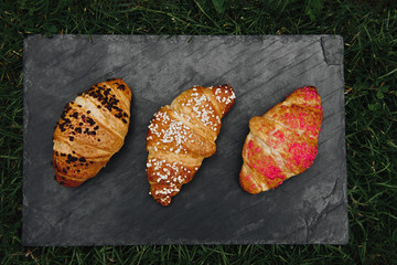 freshly baked croissants on wooden cutting board