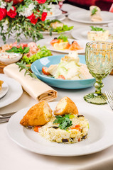 Kiev-Style Cutlet with Breadcrumbs at the banquet table. European food in a restaurant setting. Kiev-Style Cutlet in White Creamy Sauce with rice, cordon bleu chicken cutlet, dishes, snack.