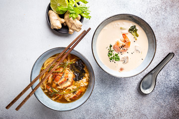 Set of Serving Asian Soups on gray background top view. Tom Yum Soup, Eel Fish Soup and Ramen noodle Soup