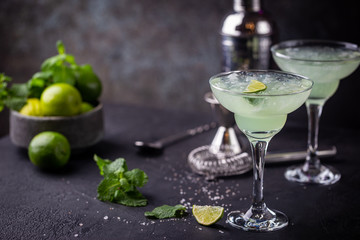 margarita cocktail with lime in a glass on dark background