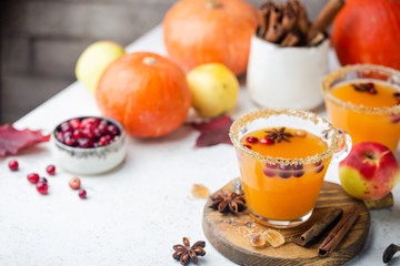 Spicy hot pumpkin punch or sangria in a glass with apple, cinnamon, anise. Halloween and Thanksgiving. Traditional autumn, winter drinks and cocktails