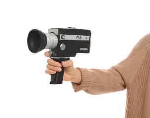 Woman with vintage video camera on white background, closeup of hand