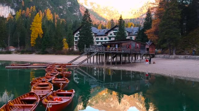 Boats on the Lago di Braies lake in Dolomites at sunrise, Italy