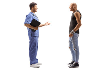 Male doctor in a blue uniform talking to a male hipster