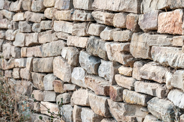 the old stones in the wall are laid carelessly