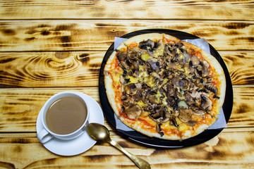 white cup with coffee and slices of pizza, top view, selective focus
