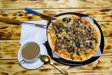 white cup with coffee and slices of pizza, top view, selective focus