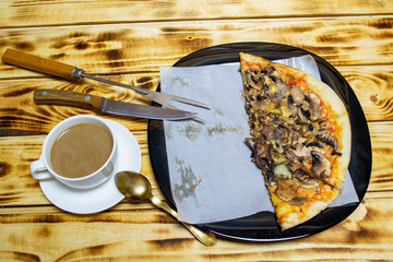 white cup of coffee with milk and pizza with mushrooms vegetables and cheese, top view, selective focus