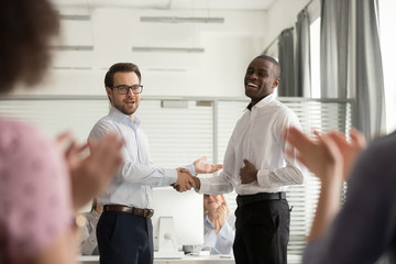 Millennial boss handshake black colleague congratulating with promotion - obrazy, fototapety, plakaty
