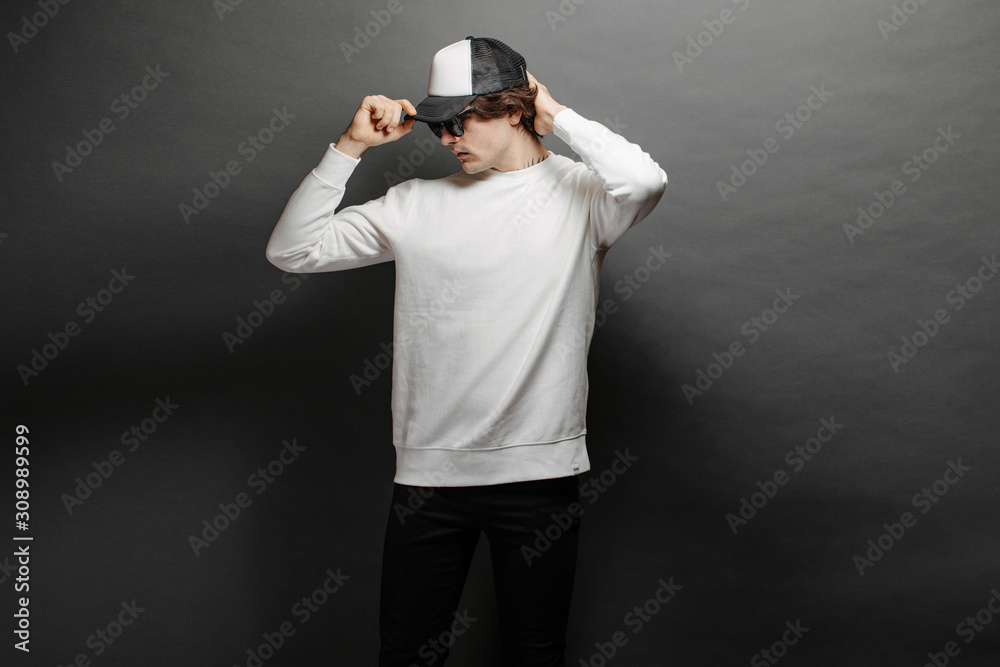 Canvas Prints man wearing blank white sweatshirt and empty baseball cap standing over gray background. sweatshirt  - Canvas Prints
