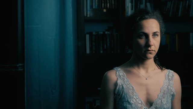 psichotic depressed woman looking a ghost in the mirror
