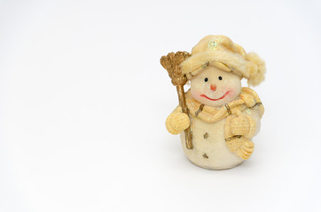 Cute cheerful snowman figurine with a broom on a white background. Minimal christmas composition. Layout for festive background with copy space. Closeup