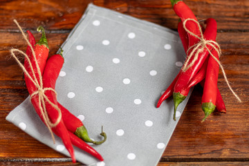 Hot red chili peppers on a wooden surface. Spicy additive in dishes.