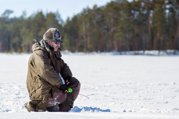 Fototapeta na wymiar Winter season, Siberia winter fishing, winter sports. Men's hobby, fishing in the winter