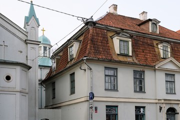 Fototapeta na wymiar Riga, Latvia, November 2019. Old house near the wall of a catholic cathedral. 