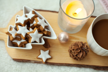 Christmas cookies stars, cocoa on a wooden board. Christmas decor, candles, plaid.