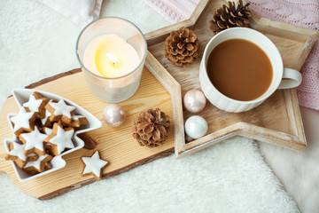 Christmas cookies stars, cocoa on a wooden board. Christmas decor, candles, plaid.