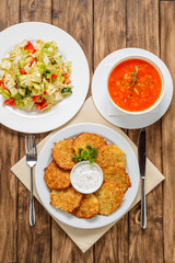Lunch with potato pancakes, salad and hodgepodge