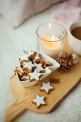 Christmas home decor in pink colors. Mug of hot cocoa, cookies, candle.