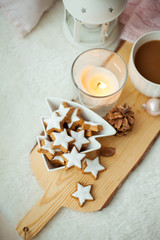 Obraz na płótnie Canvas Christmas cookies stars, cocoa on a wooden board. Christmas decor, candles, plaid.