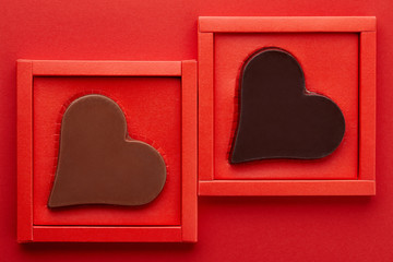 Valentines day chocolate hearts on red background