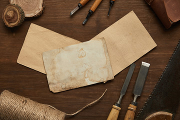top view of aged carpentry tools near blank vintage papers on wooden table
