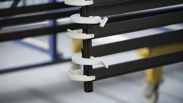 Coloured Aluminum profiles after anodizing process in the factory. Electrolytic passivation process to increase the thickness of natural oxide layer on the surface of metal parts.