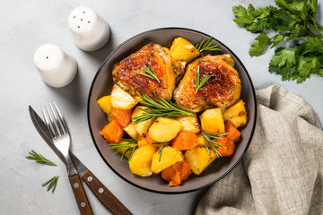 Baked chicken with vegetables top view. © nadianb
