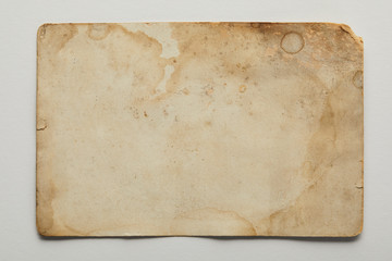 top view of vintage dirty beige paper on grey background