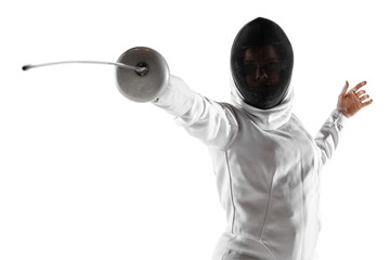 Teen girl in fencing costume with sword in hand isolated on white studio background. Young female...